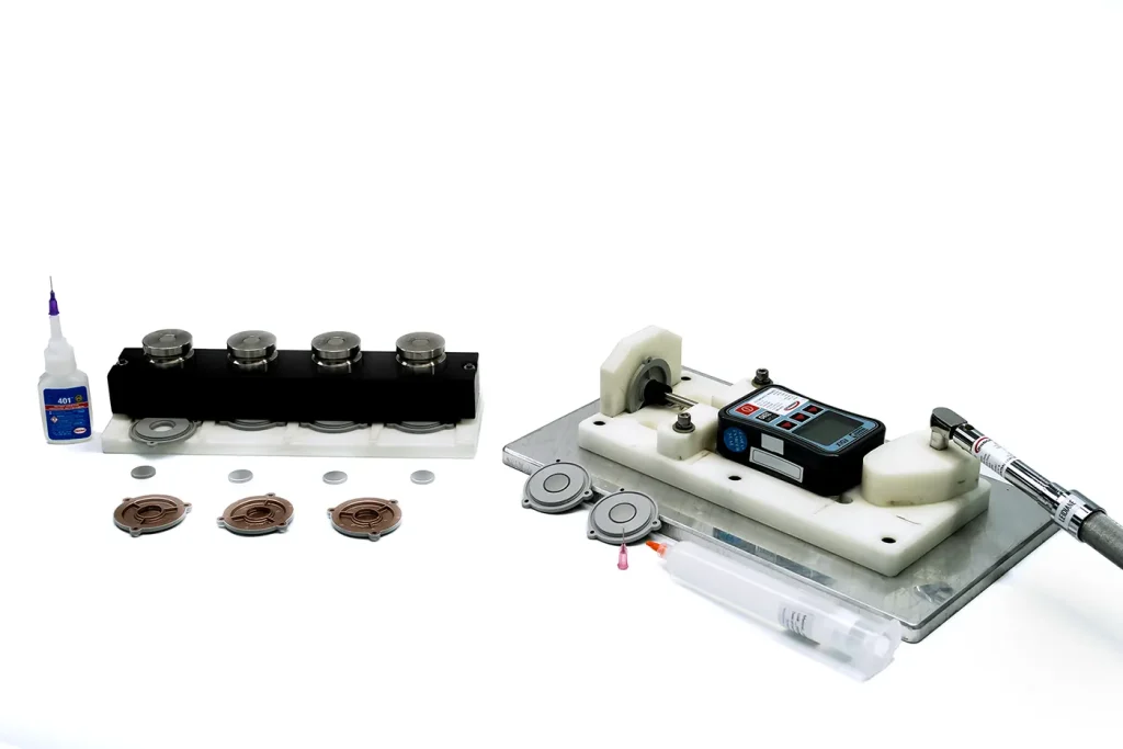 This suite of parts encompasses many capabilities: we buy the raw plastic, EMI coat the parts in a hard masking tool, apply a FIP gasket, assemble parts together, and force test them with the apparatus shown at far right.